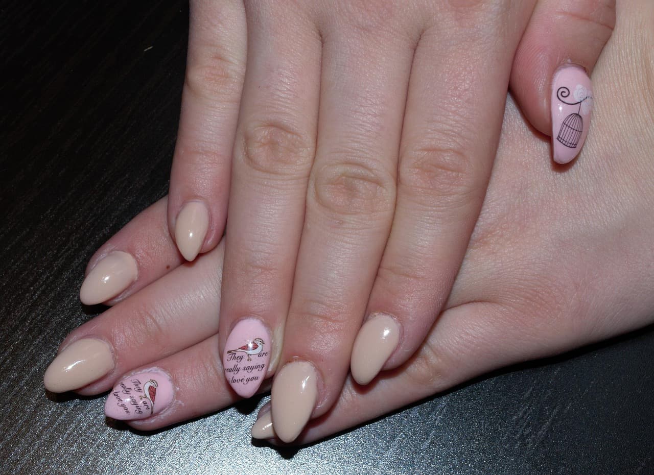 Nude almond acrylic nails with fine line designs